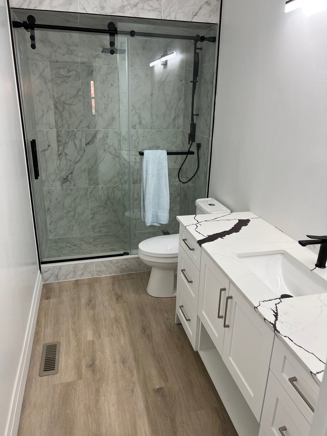 Finished walk-in tile shower after renovation in Courtice by Cornerstone Construction