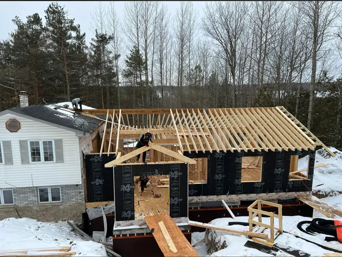 Home addition under construction, framing and roof trusses