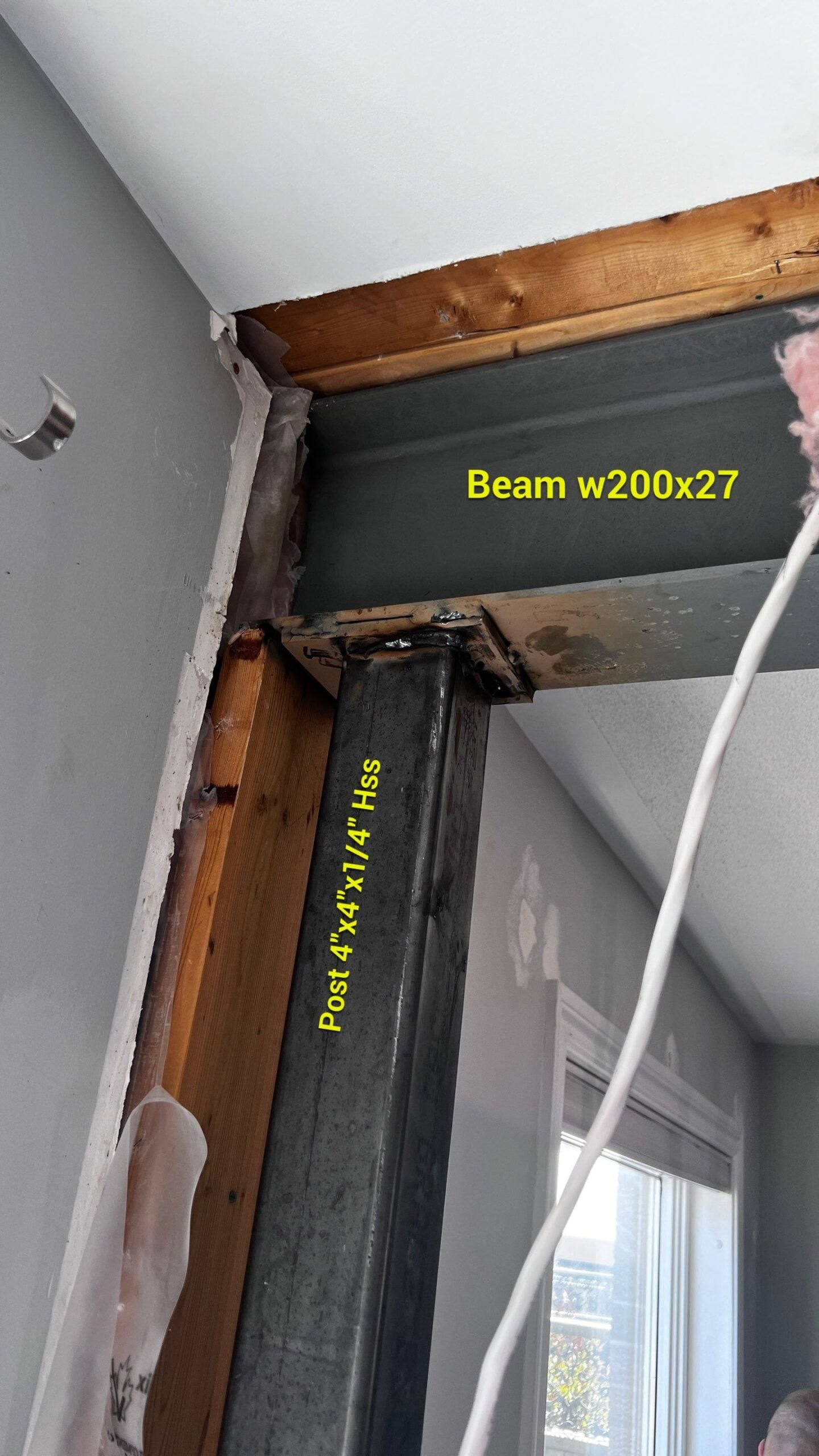 Structural steel beam being installed to replace the load-bearing wall